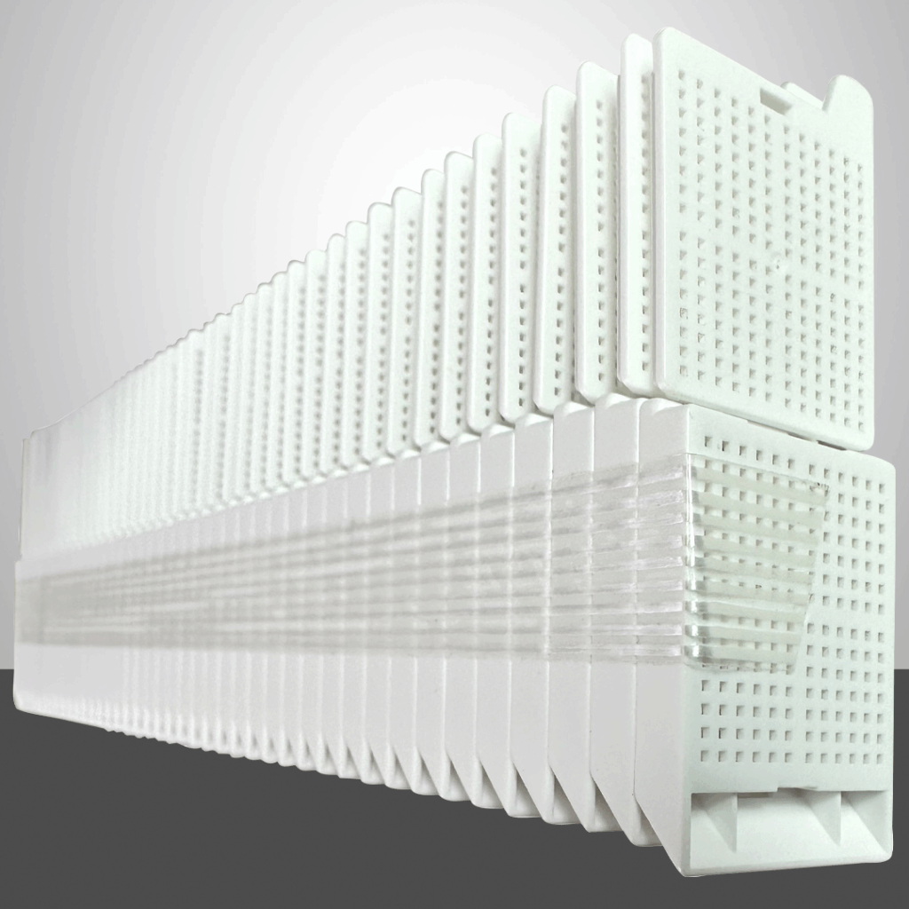 These biopsy embedding cassettes, featuring detachable lids, are conveniently taped and ready for use. White color